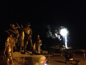 Life-sized sculptures on Dave Rubin's The Rock appear to be watching the fireworks show late on the Fourth of July.
