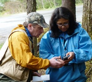 5-13 University of Alaska Southeast anthropology professor Dan Monteith goes over GPS data with Bernadine DeAsis during a dig on the UAS campus. (Ed Schoenfeld, CoastAlaska News)