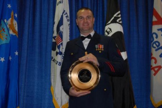 Petty Officer 1st Class Christopher Taylor displays a commemorative plate given to him by the Armed Forces YMCA of Alaska. U.S. Coast Guard photo by Petty Officer 1st Class Shawn Eggert.