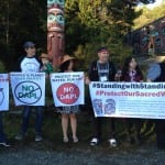 Protesters carry signs opposing the Dakota Access Pipeline.