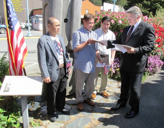 Rogelio Casilla, Crispin Casilla and Gulagdo Rarican receive their certificates of citizenship Friday from immigration services officer Gary Johnson.