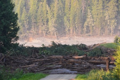 Muddy water from the breached Mount Polley Mine tailings pond dam floods a downstream creek and road Monday. (Cariboo Regional District Emergency Operations Centre photo)