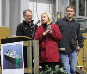 First Lady Donna Walker displays the metal plate bearing her initials. The plate will be welded to the keel of one of the new Alaska Class ferries. Also pictured are Doug Ward, left, and Eugene Doyon, who welded Walker's initials onto the metal plate.