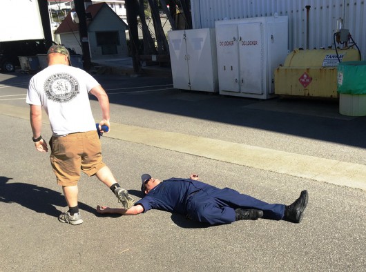 A Coast Guardsman acting the part of an active shooter walks by one of his "victims" during an active shooter drill at the Ketchikan base. (Photo by Leila Kheiry)