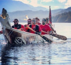 Klawock's Heinyaa Kwaan canoe crew paddling into Kasaan for Rededication of the Whalehouse; Lawrence Armour, Robert Jackson, Jonathan Rowan, Ronnie Fairbanks, Leslie Isaacs and John Smith (copyrighted photo by Marijane Armour used by permission).
