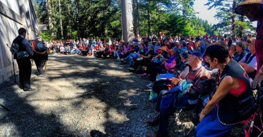 Richard Peterson of Kasaan, Central Council Tlingit and Haida President, addressing the hundreds of guests in front of the Whalehouse (copyrighted photo by Marijane Armour used with permission).