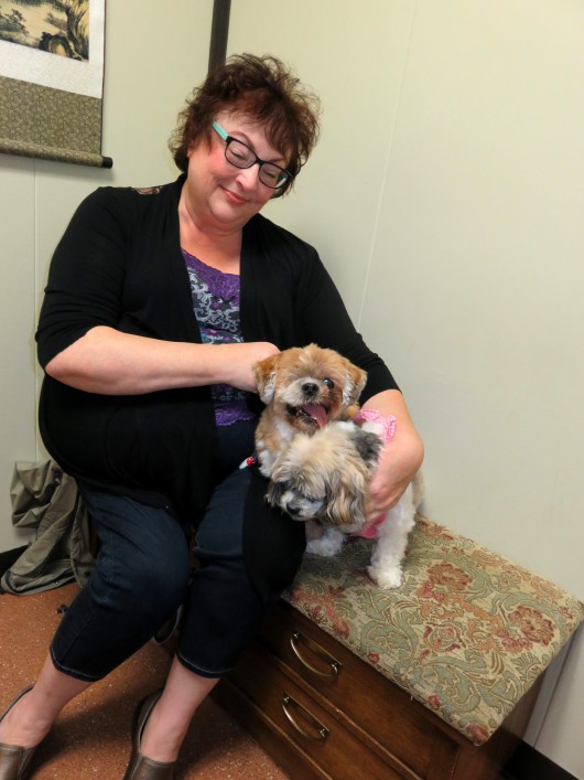 Michelle Batten of Portland gives Canna-Pet capsules to her two aging dogs, Willy and Gracie. (NNN photo by Tom Banse)